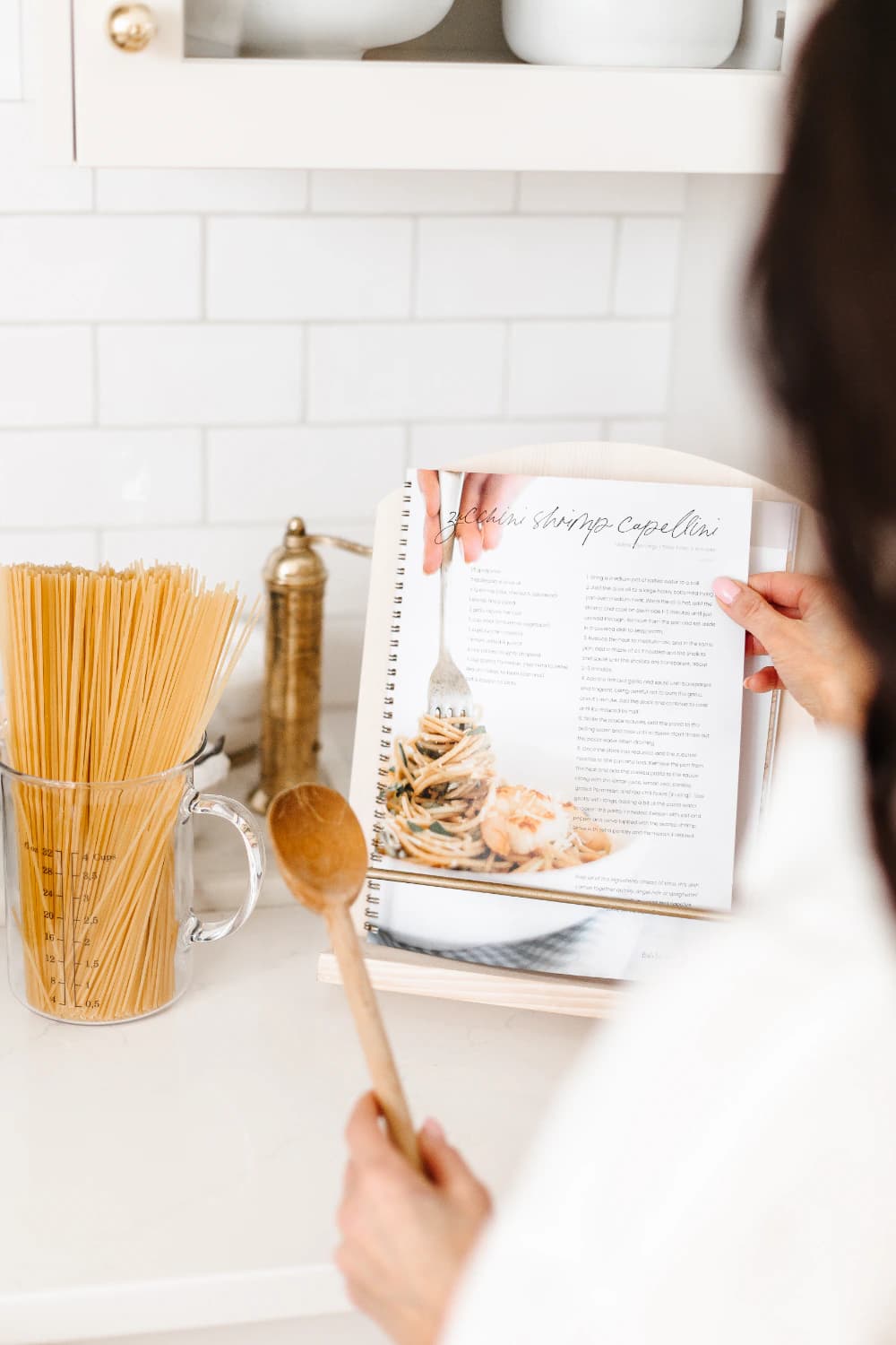 The Fraîche Start workbook open to a zucchini shrimp capellini recipe on a kitchen stand