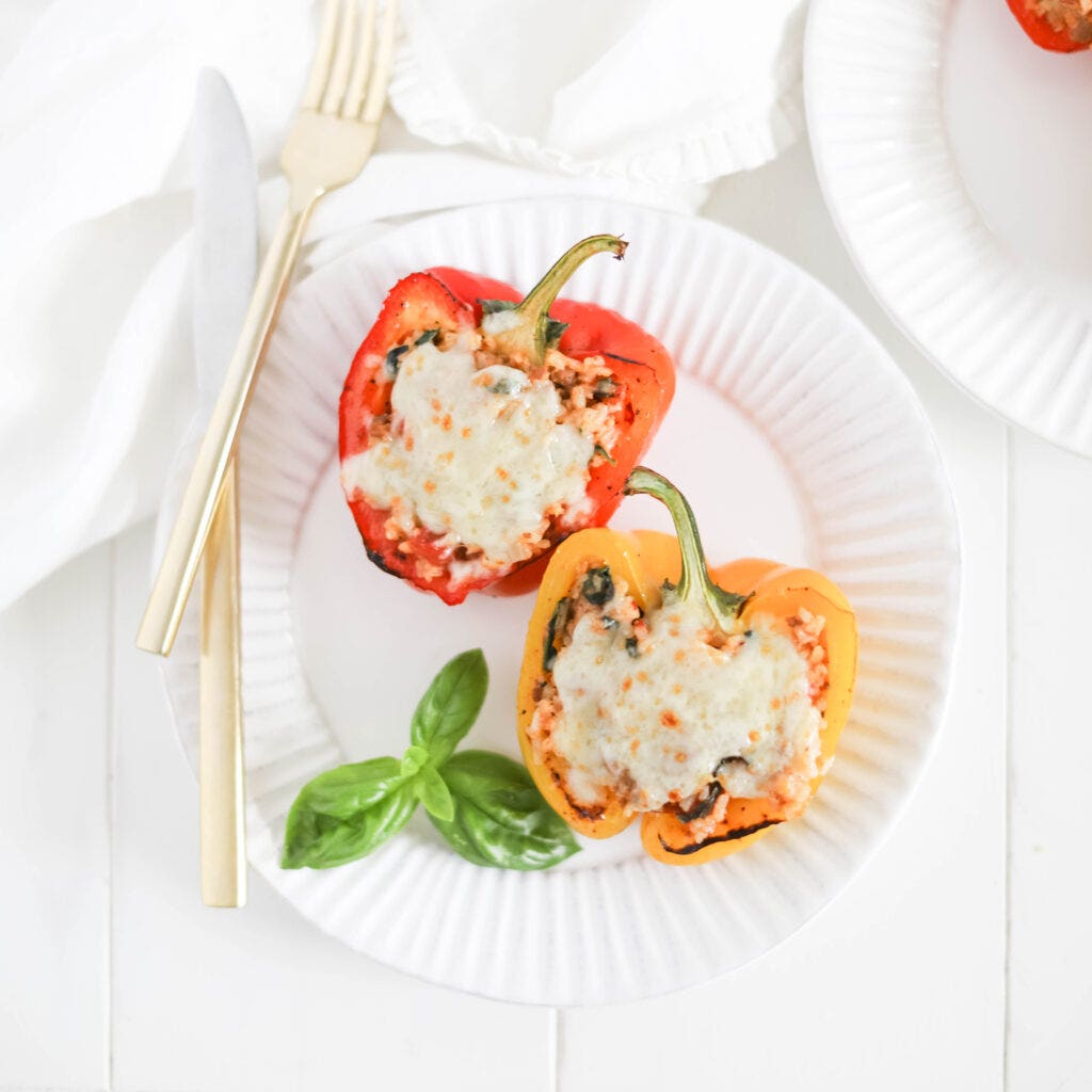 2 stuffed bell peppers on a plate 