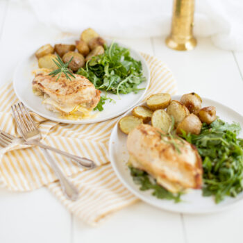 Chicken plated with arugula salad and potatoes