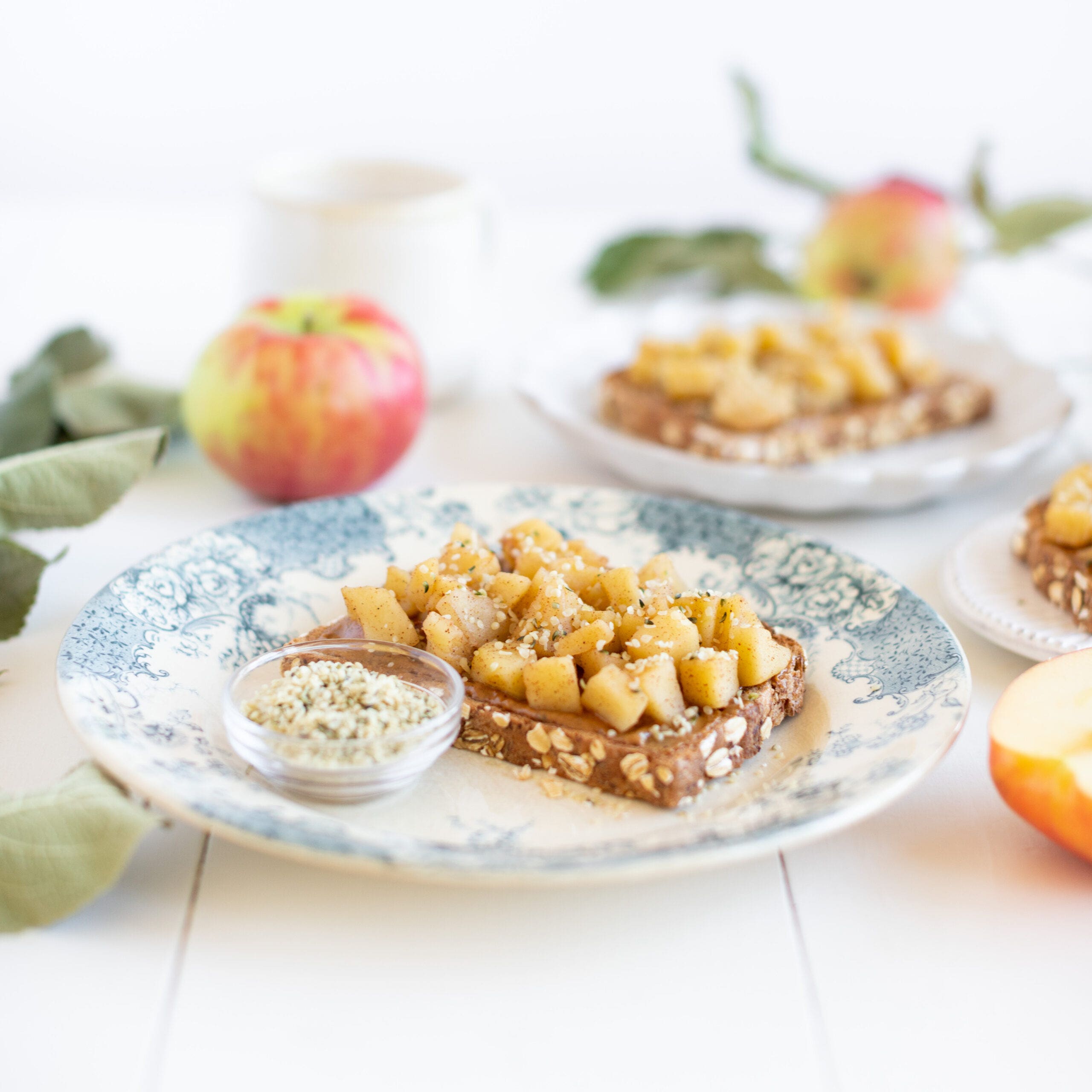 bread topped with cooked apples and garnished with hemp hearts