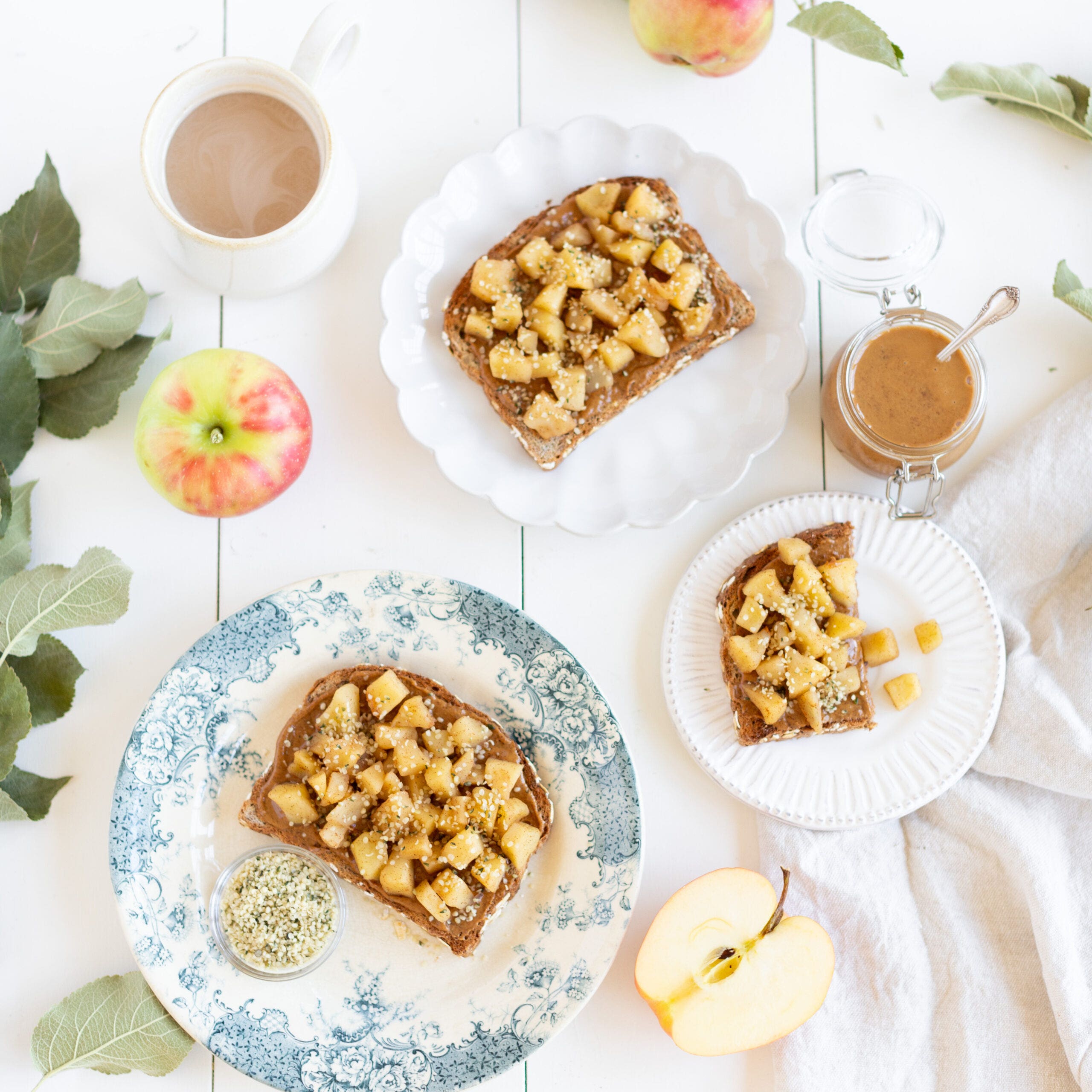 bread topped with cooked apples and garnished with hemp hearts