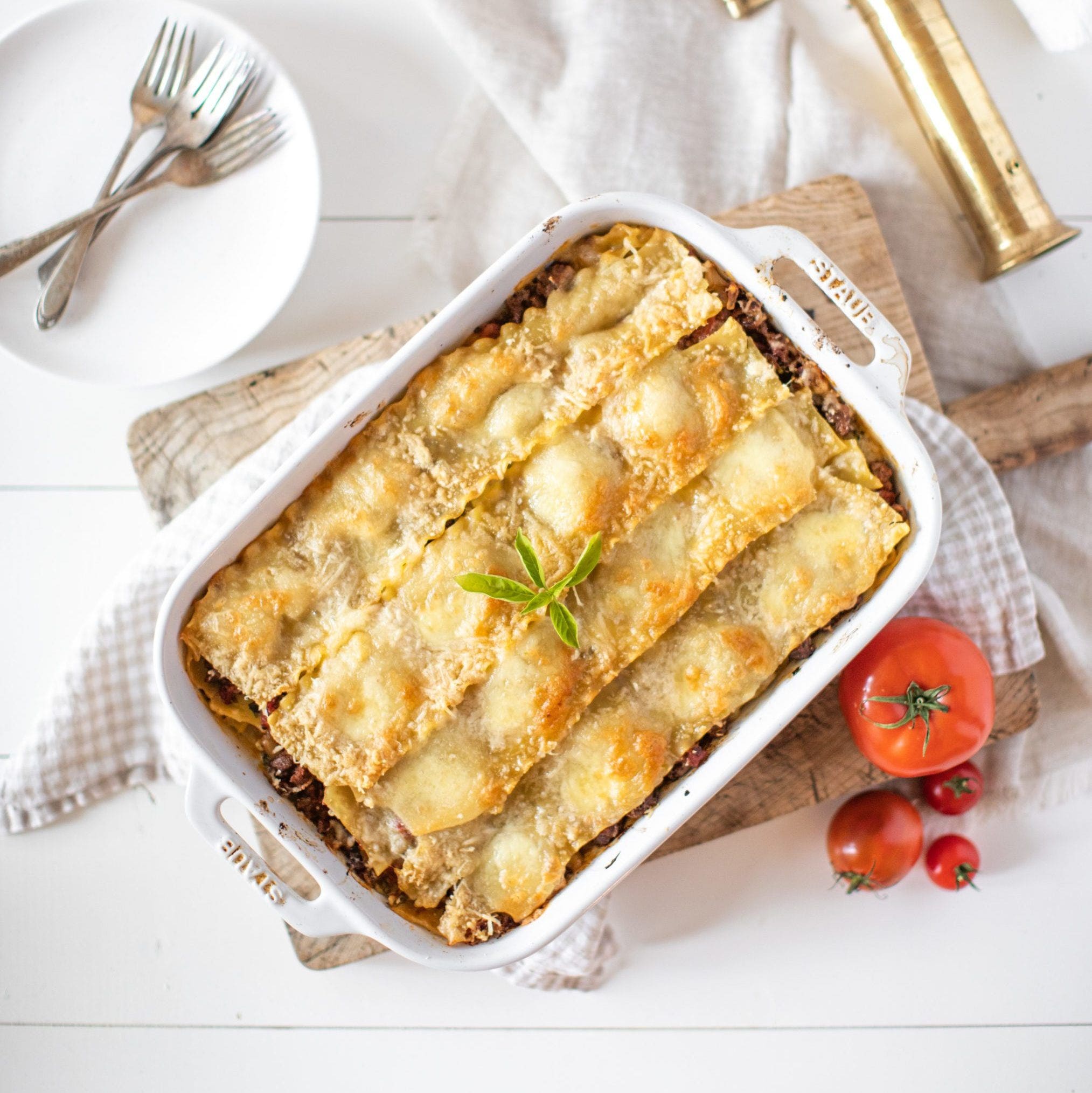 golden brown lasagna garnished with basil