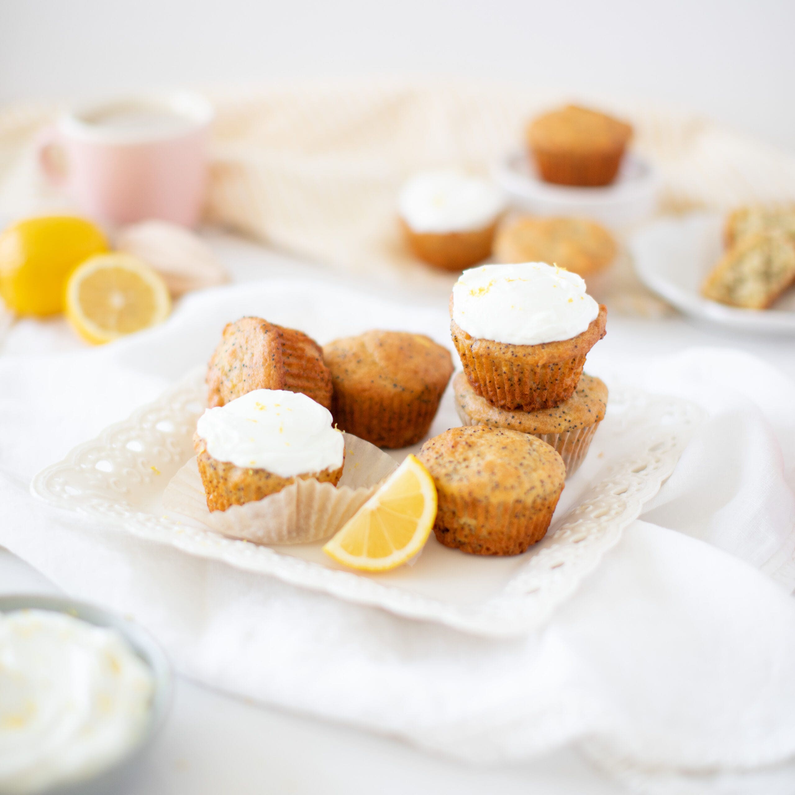 Lemon Poppyseed muffins stacked on a plate with Greek yogurt