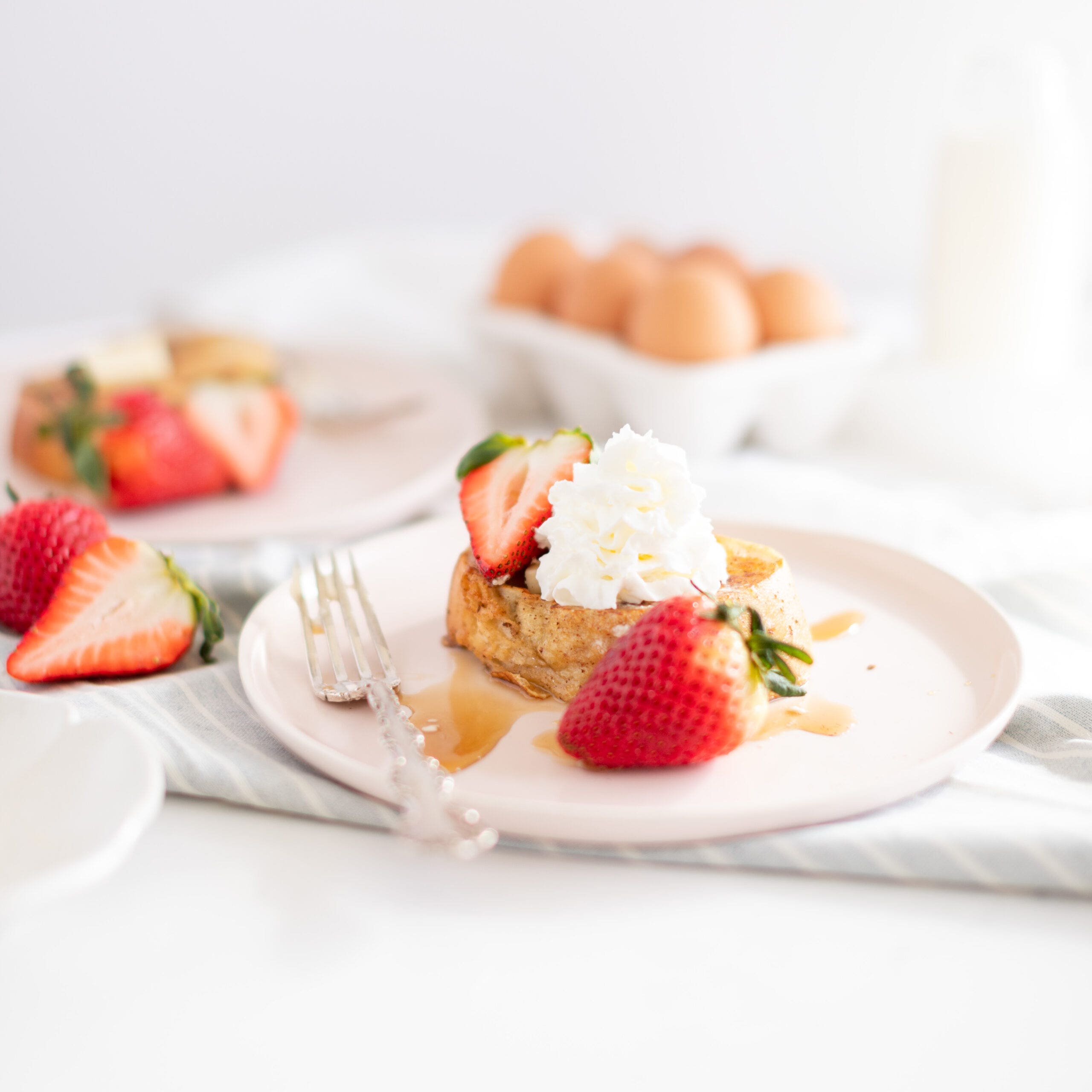 french toast with whip cream and strawberries