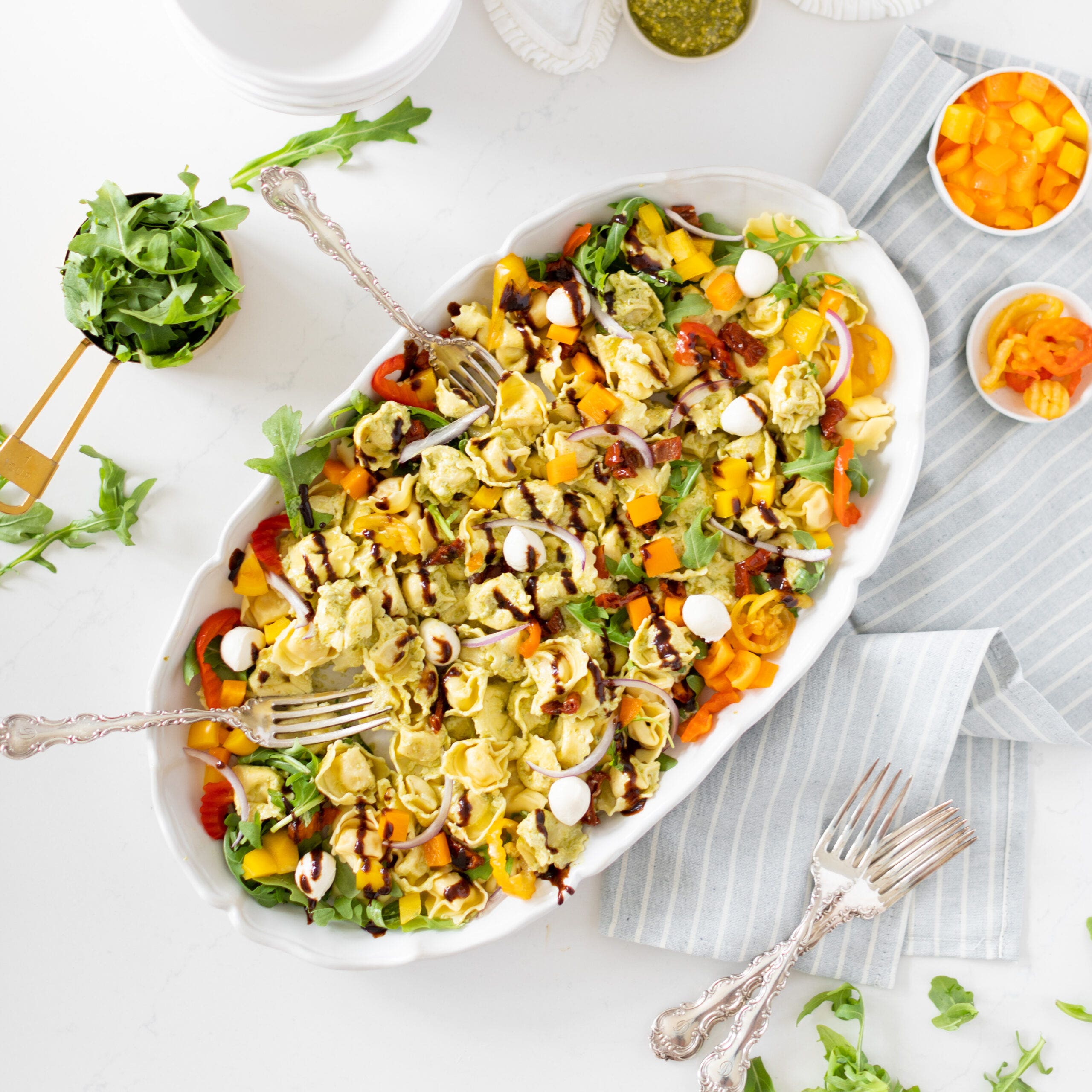 tortellini salad drizzled with balsamic glaze