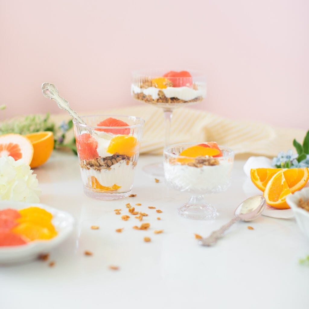 citrus yogurt parfaits with granola topped with oranges in bowls