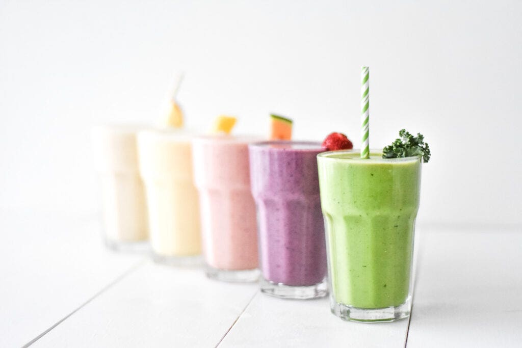 lineup of 5 smoothies all in different bright colours